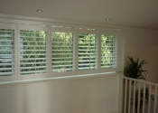 white-shutters-with-top-tracking
